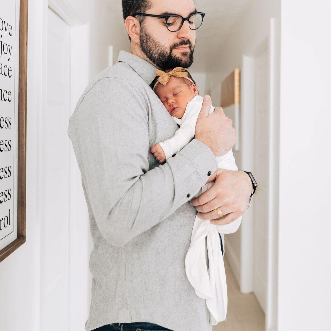 Dad holding a baby wearing Lou Lou and Company Knotted Gown - Finley