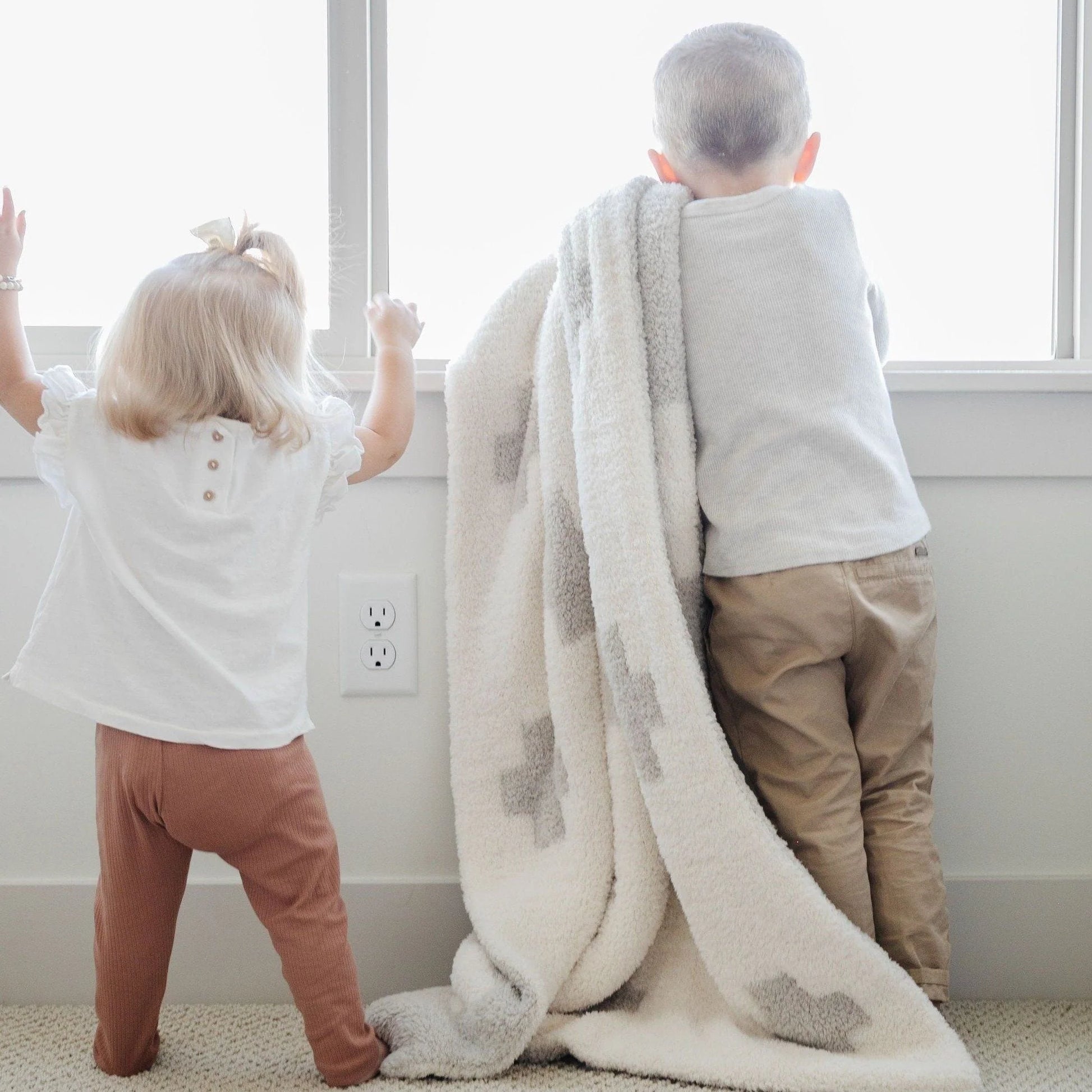 Little Boy holding Saranoni Receiving Double-Layer Bamboni Blanket - Swiss Cross