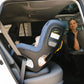 Mom in driver seat looks back to check on baby sitting in UPPAbaby Rove Convertible Car Seat - Cody - Coastal Blue Mélange