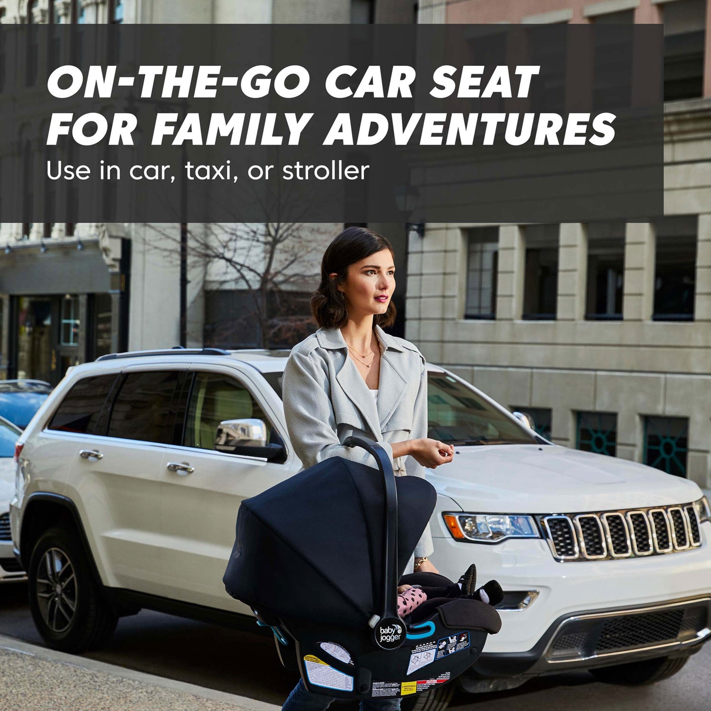 Woman carries Baby Jogger City GO 2 Infant Car Seat