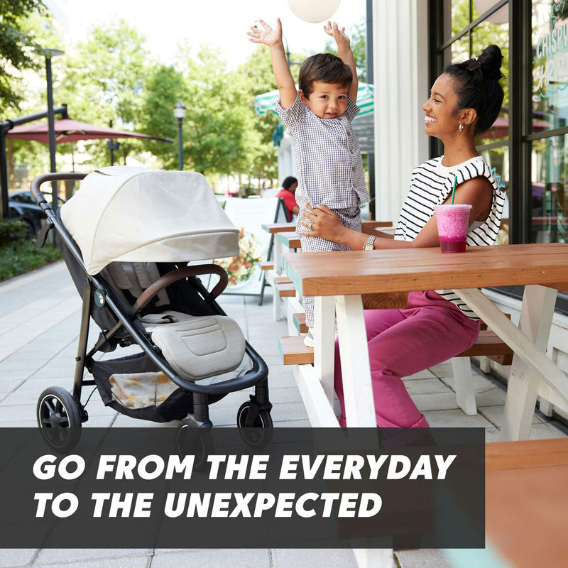 Mom and child at table at cafe with Baby Jogger City Mini Air Single Stroller - Frosted Ivory next to them