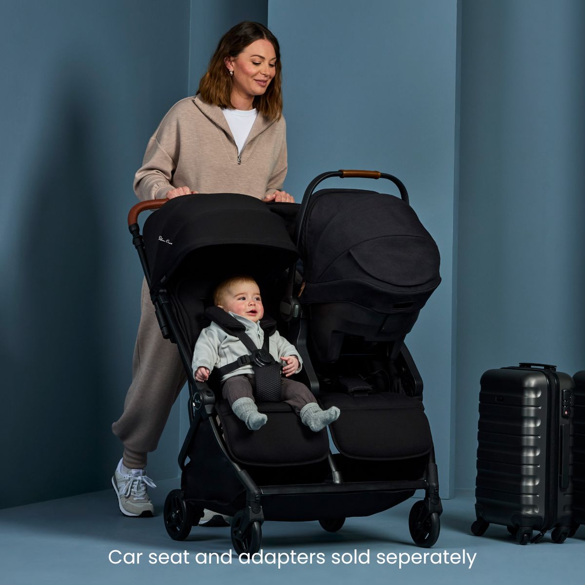 Mom pushes toddler and baby in Silver Cross Jet Double Compact Side by Side Stroller - Black