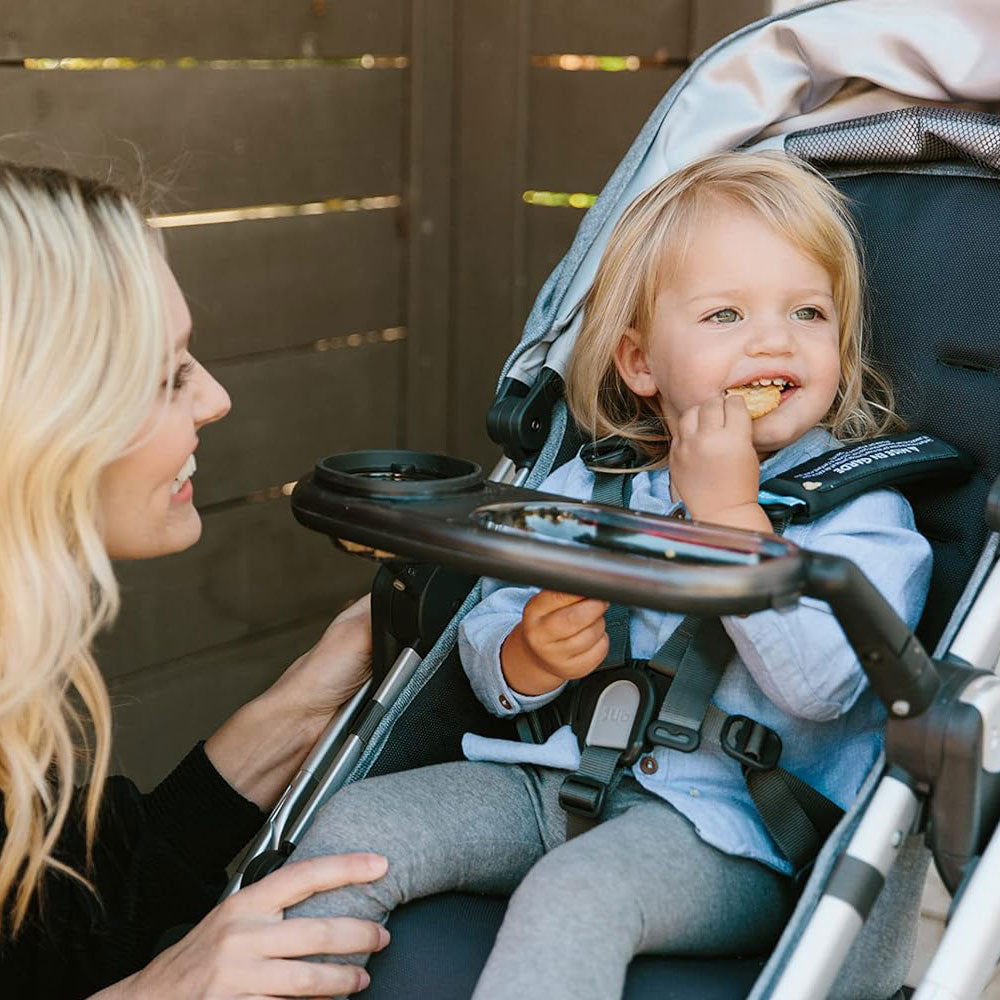 Child in stroller with UPPAbaby Snack Tray - VISTA / CRUZ / RumbleSeat