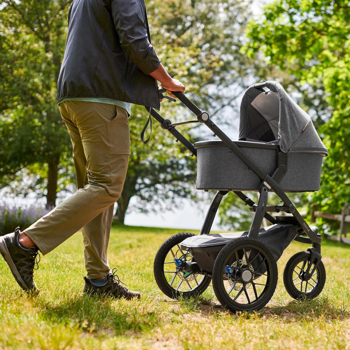 Man pushing uppababy bassinet on uppababy ridge stroller