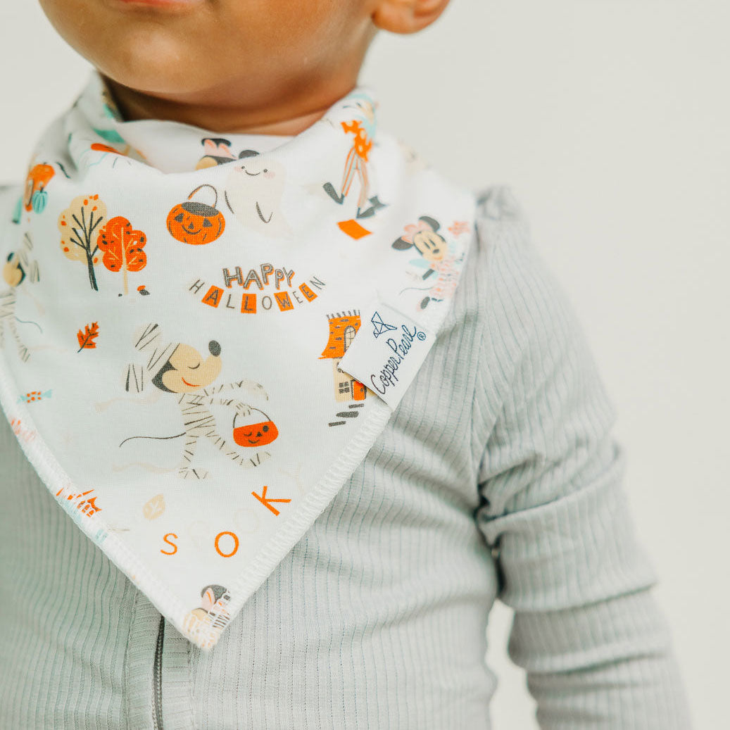 Baby wearing Copper Pearl Single Holiday Bandana Bib - Mickey Mouse's Boo Bash - White