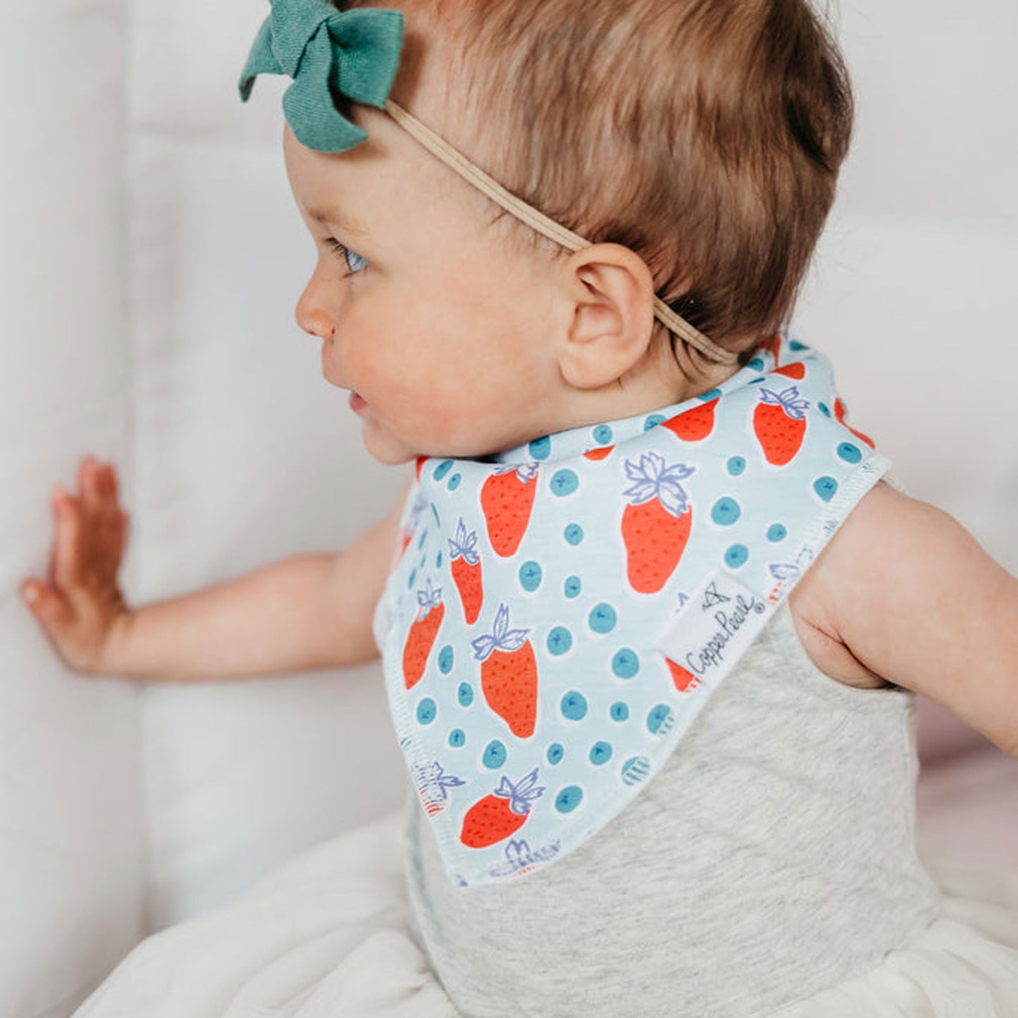 Baby wearing Copper Pearl Single Holiday Bandana Bib - Liberty Strawberry