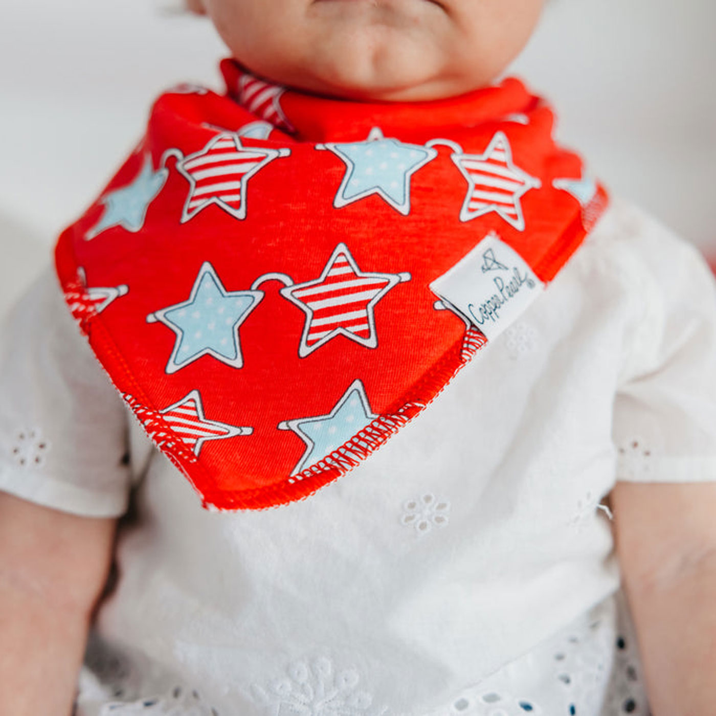 Baby wearing Copper Pearl Single Holiday Bandana Bib - Liberty Stars