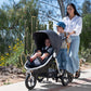 Mom pushes stroller while child rides on Bumbleride Mini Board - 2022-Now