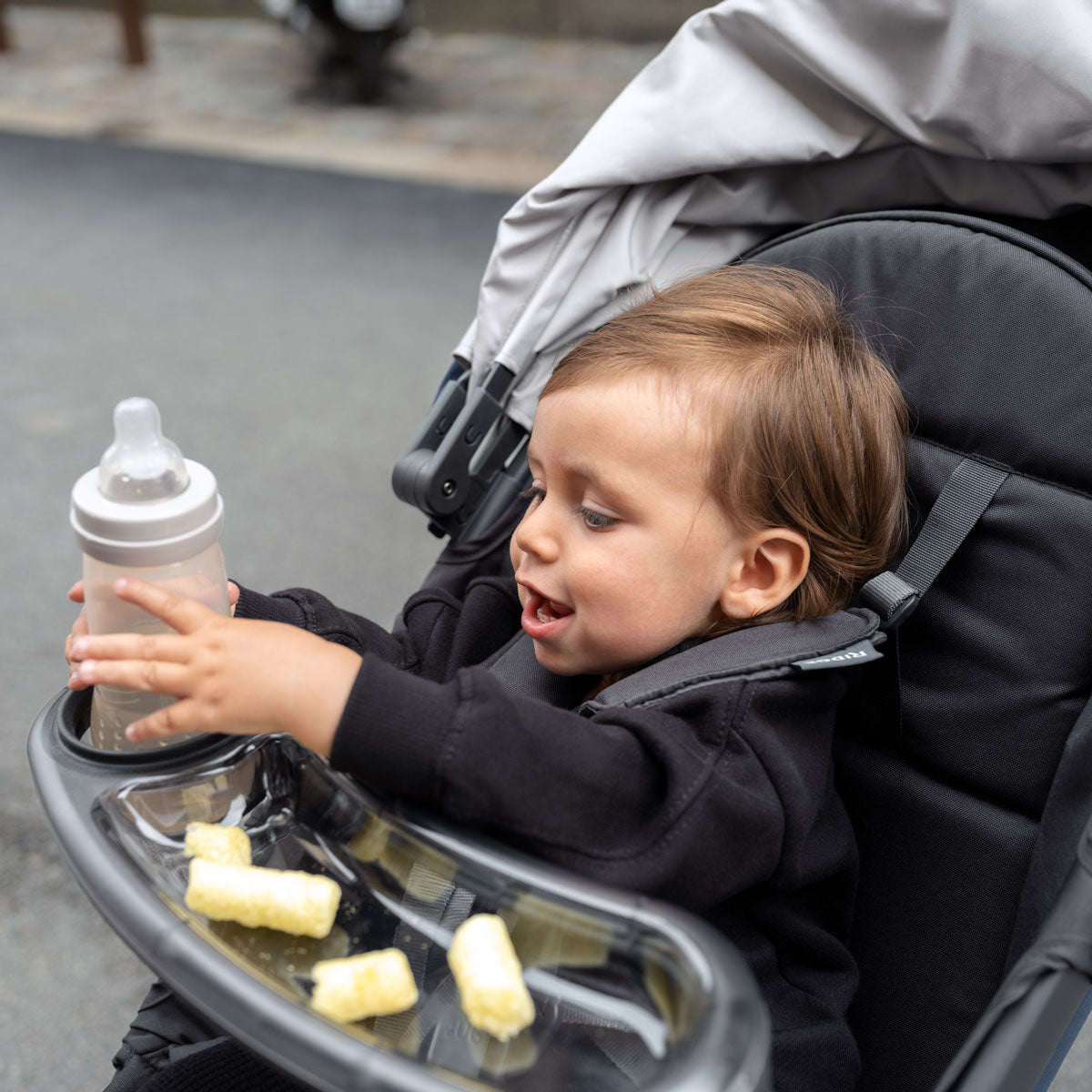 child in stroller with UPPAbaby Snack Tray - RIDGE