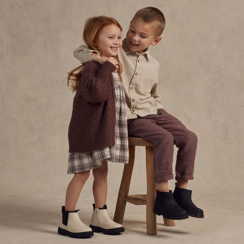 Boy wearing Rylee and Cru Kalen Pant - Plum while hugging little girl