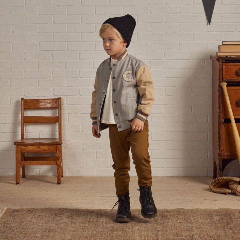 Boy wearing Rylee and Cru Varsity Jacket - Ivory / Slate