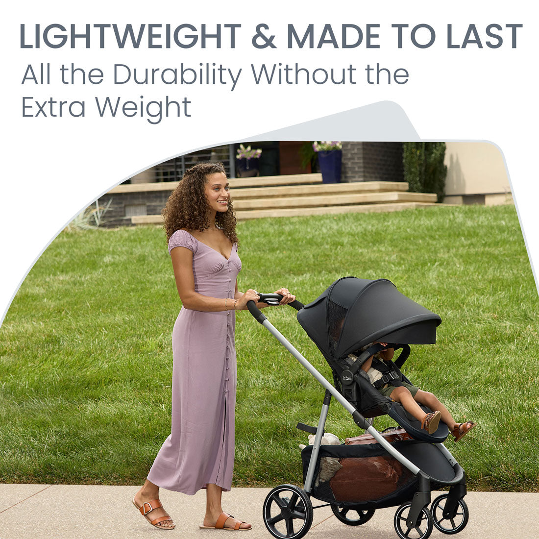 Mom pushing Britax Grove Modular Stroller - Pindot Onyx