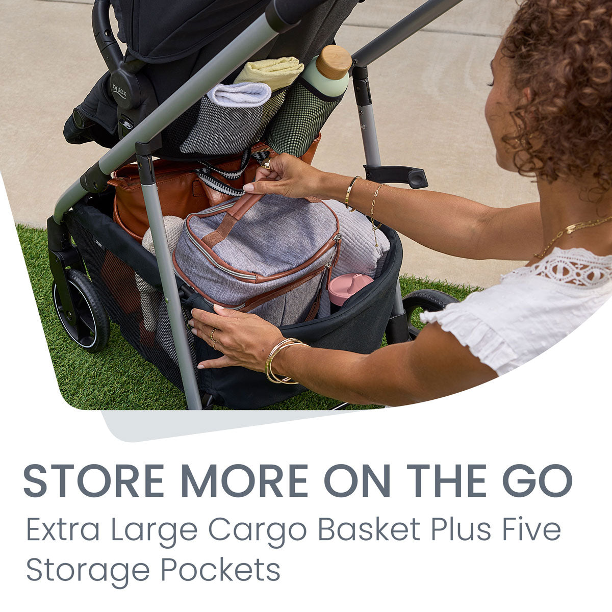 Mom storing bags in cargo basket of Britax Grove Modular Stroller - Pindot Onyx