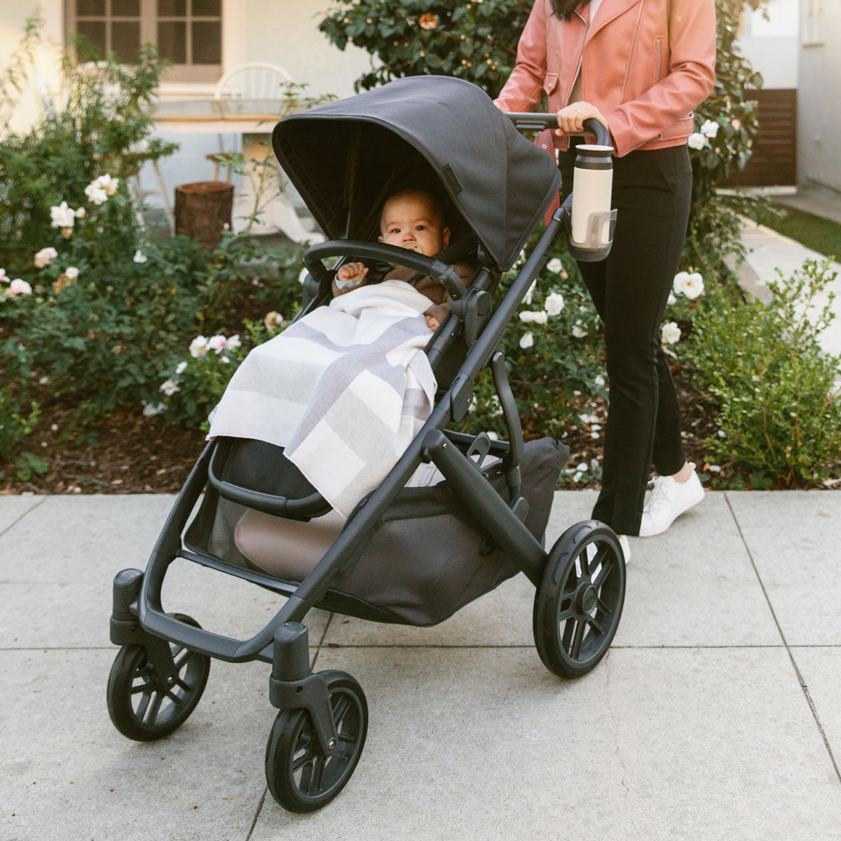 Mom pushes baby in stroller using UPPAbaby Knit Blanket - Grey