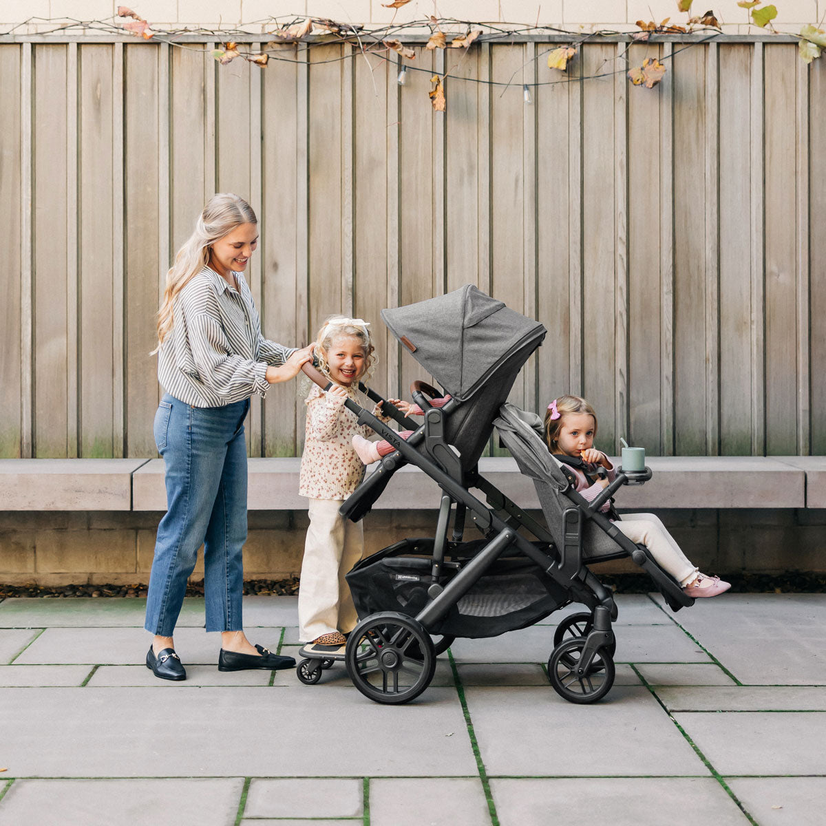 Mom pushes three children in UPPAbaby VISTA V2 and RumbleSeat V2+ Bundle - GREYSON (Charcoal Melange)