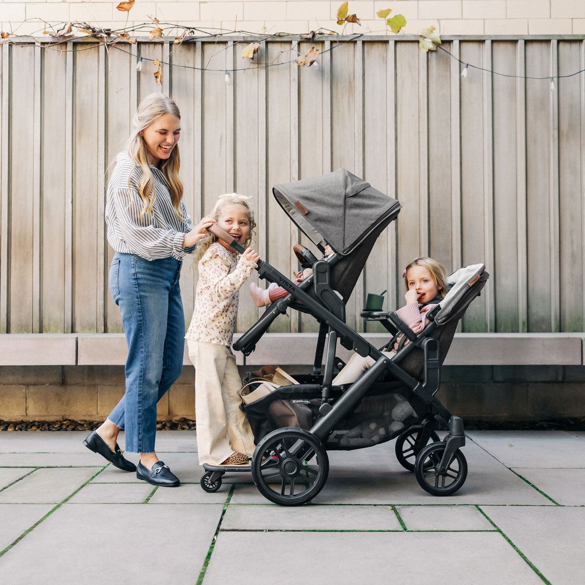 Mom pushes three children in UPPAbaby VISTA V2 and RumbleSeat V2+ Bundle - GREYSON (Charcoal Melange)