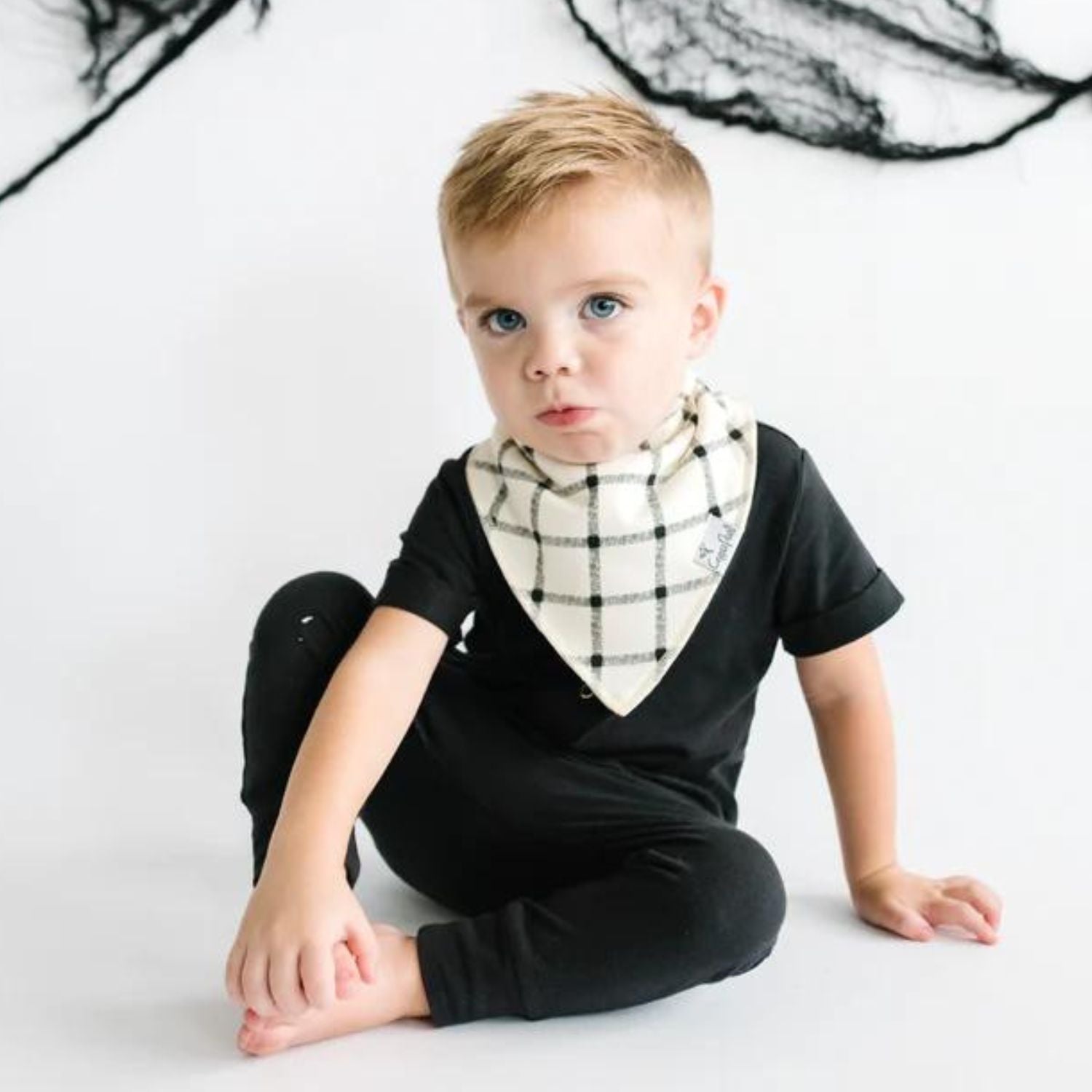 Baby wearing Copper Pearl Single Holiday Bandana Bib - White Windowpane