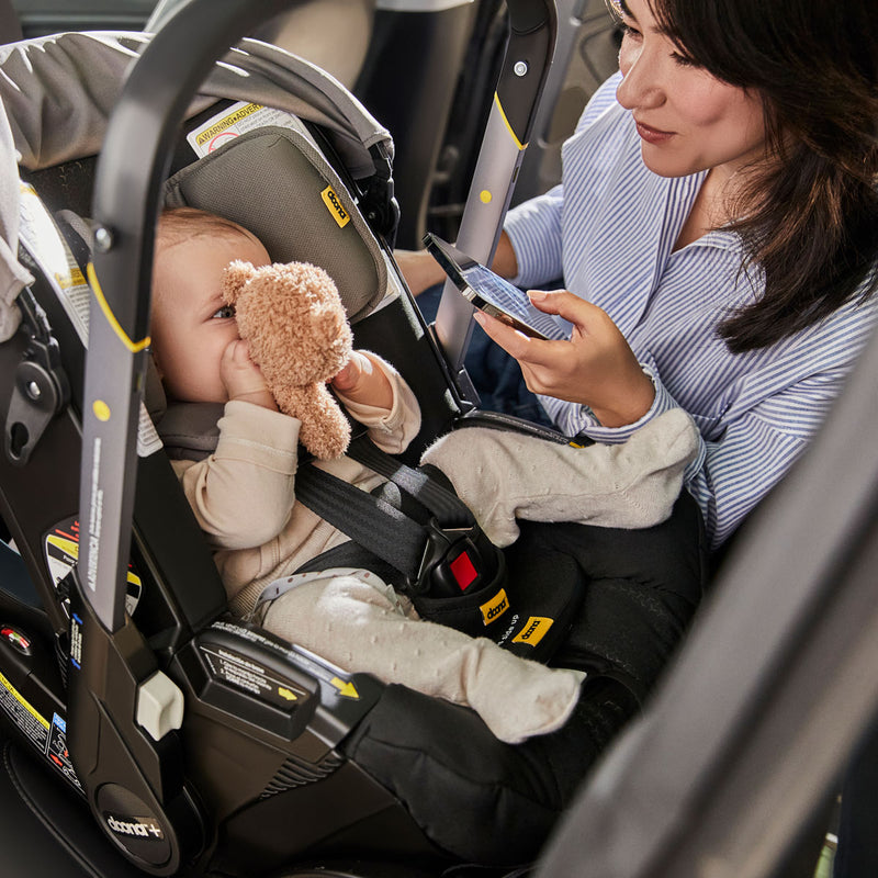 Baby in car seat with Doona SensAlert