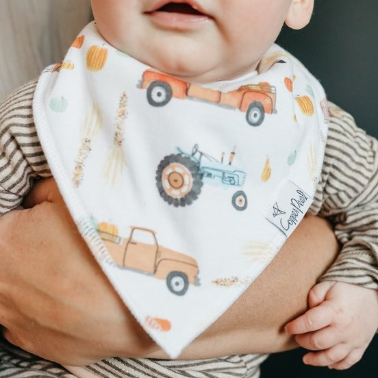 Baby wearing Copper Pearl Single Holiday Bandana Bib - Trick Harvest