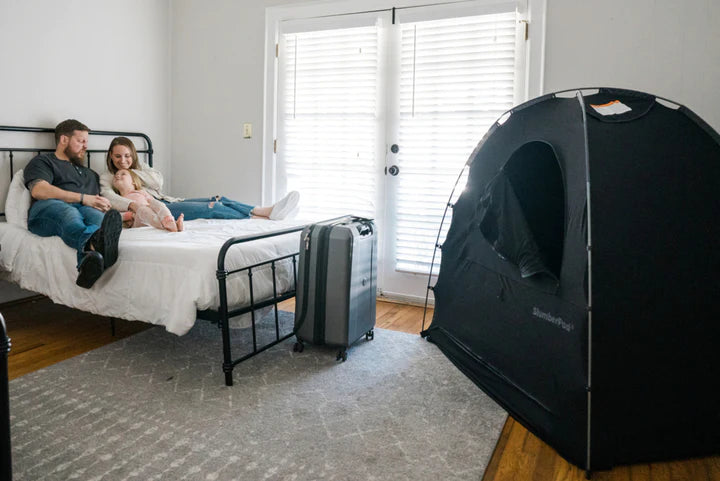 Family in bed with SlumberPod Privacy Pod with Fan - 3.0 in room