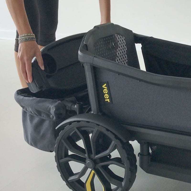 Woman putting snack tray in Veer Cruiser Foldable Storage Basket