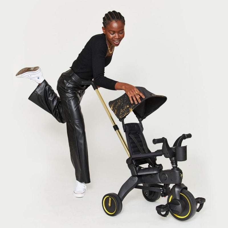 Woman pushing Doona Liki Trike - Gold