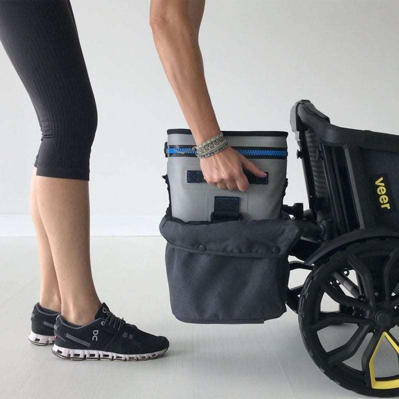 Woman putting item in Veer Cruiser Foldable Storage Basket