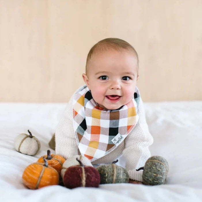 Baby wearing Copper Pearl Single Holiday Bandana Bib - Holiday Harvest Plaid