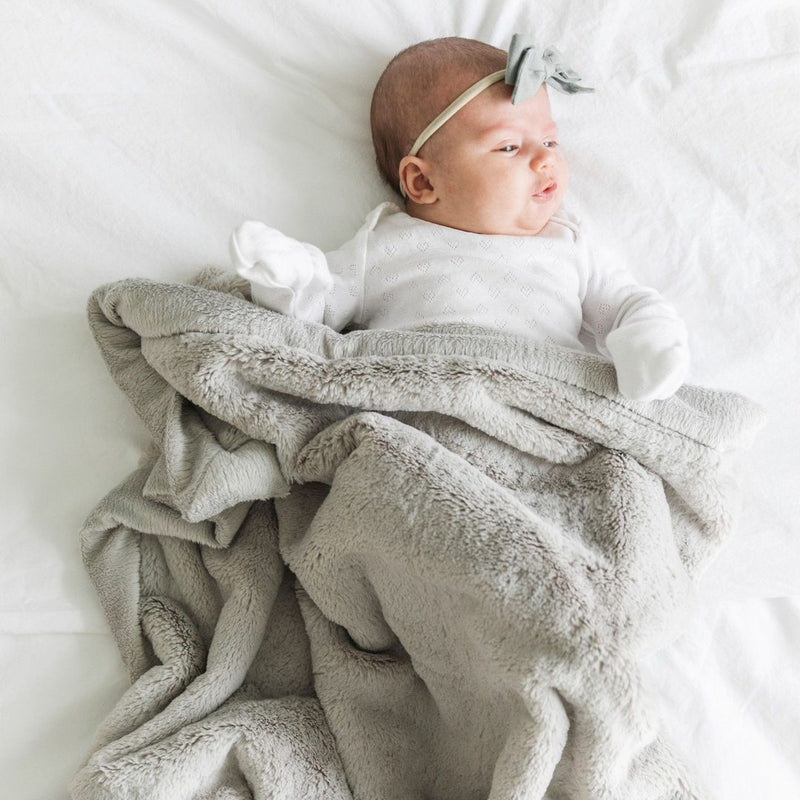 Baby laying in Saranoni Receiving Lush Blanket - Feather