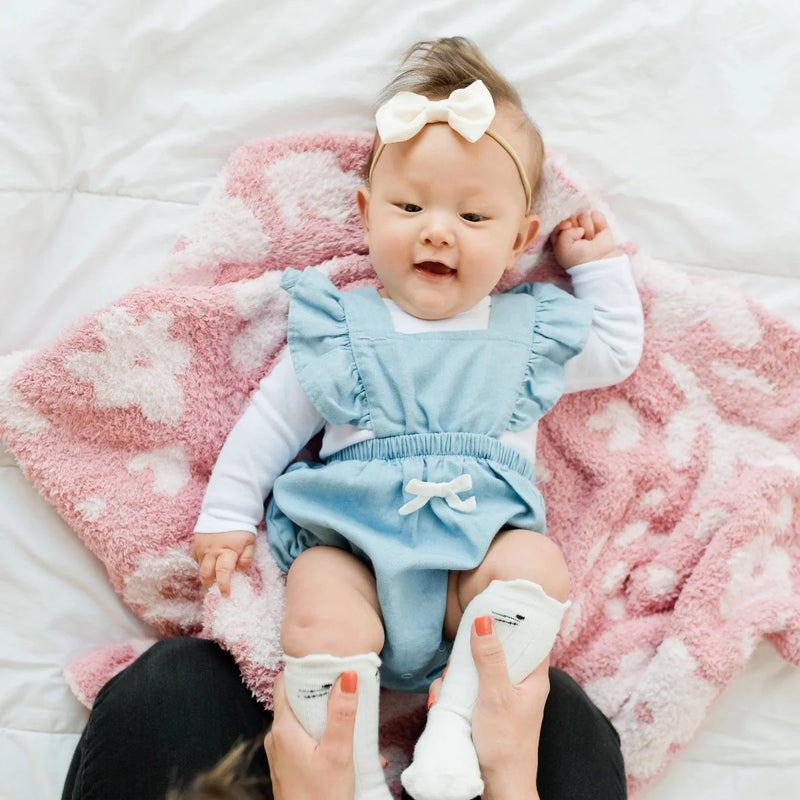 Baby laying on Saranoni Receiving Double-Layer Bamboni Blanket - Petal